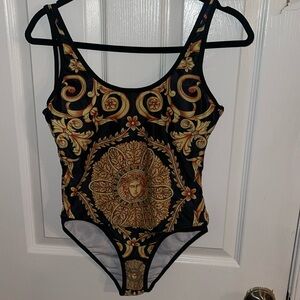 This black and gold bodysuit/ swimsuit is perfect to dress up or down